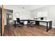 Bright home office with dark wood floors, large windows, and an extensive desk at 755 Fairlawn Dr, Orange City, FL 32763