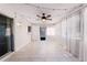 Bright, empty sunroom with tile floor, ceiling fan, string lights and white curtains at 755 Fairlawn Dr, Orange City, FL 32763