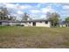 Expansive backyard featuring a well-maintained lawn and a charming patio area, perfect for outdoor relaxation and entertaining at 818 W Pennsylvania Ave, Deland, FL 32720