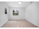 Bright bedroom with a large window and neutral carpeting creates a relaxing atmosphere at 818 W Pennsylvania Ave, Deland, FL 32720