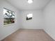 Bright bedroom with two windows and neutral carpeting creates a relaxing atmosphere at 818 W Pennsylvania Ave, Deland, FL 32720