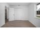 Cozy bedroom with plush carpeting, fresh white paint, a closet, natural light, and modern styling at 818 W Pennsylvania Ave, Deland, FL 32720