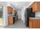 Updated kitchen featuring wood cabinets, granite countertops, stainless steel appliances, and a tile backsplash at 818 W Pennsylvania Ave, Deland, FL 32720