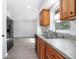 Updated kitchen featuring wood cabinets, granite countertops, stainless steel appliances, tile backsplash, and new sink at 818 W Pennsylvania Ave, Deland, FL 32720