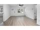 Bright open living space featuring a large window, modern flooring, fresh white paint, and contemporary design at 818 W Pennsylvania Ave, Deland, FL 32720