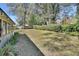 Large backyard offers plenty of green space with mature trees and privacy shrubs at 857 Westchester Dr, Deland, FL 32724