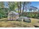 Backyard featuring a greenhouse and raised garden beds, perfect for gardening enthusiasts at 857 Westchester Dr, Deland, FL 32724