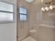 Bathroom shower featuring glass doors, bright tile, and a rainfall shower head at 857 Westchester Dr, Deland, FL 32724