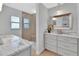 Bathroom with marble counters, drawers, shower with glass doors, and wood look flooring at 857 Westchester Dr, Deland, FL 32724
