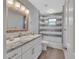 Bathroom featuring a marble countertop, a glass enclosed shower, and wood look floors at 857 Westchester Dr, Deland, FL 32724