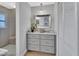 Bathroom vanity with granite countertop, drawers, and view to the glass shower at 857 Westchester Dr, Deland, FL 32724