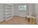 Spare bedroom with shelving, wood look floors, curtains, and a side table at 857 Westchester Dr, Deland, FL 32724