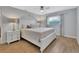 Bedroom with wood floors, ceiling fan, neutral walls, and ample natural light at 857 Westchester Dr, Deland, FL 32724