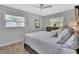 Comfortable bedroom featuring two windows, wood look floors and a dresser with stylish decor at 857 Westchester Dr, Deland, FL 32724