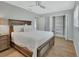 Bedroom featuring a ceiling fan, wood look floors, and an open closet with shelves at 857 Westchester Dr, Deland, FL 32724