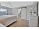 Bedroom with wood floors, barn door and view of ensuite bath at 857 Westchester Dr, Deland, FL 32724