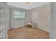 Spare bedroom with wood look floors, curtains, and a accent wall at 857 Westchester Dr, Deland, FL 32724