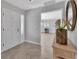 Elegant entryway featuring herringbone floors, decorative console, and a glimpse into a bright living area at 857 Westchester Dr, Deland, FL 32724