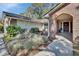 Charming home featuring a brick archway entrance and a meticulously landscaped front yard at 857 Westchester Dr, Deland, FL 32724