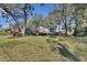 Landscaped front yard featuring mature trees and a well-maintained lawn, providing a serene outdoor space at 857 Westchester Dr, Deland, FL 32724