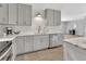 Kitchen with white subway tile backsplash, stainless steel appliances, and gray cabinets at 857 Westchester Dr, Deland, FL 32724