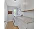 Laundry room with granite countertops, overhead cabinets and new washer and dryer at 857 Westchester Dr, Deland, FL 32724