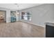 Open floor plan living area with hardwood flooring, bright natural light, and turquoise cabinet at 857 Westchester Dr, Deland, FL 32724