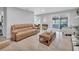 Cozy living room with wood-look tile, a leather couch, and view to the outdoors at 857 Westchester Dr, Deland, FL 32724