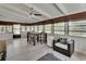 Bright sunroom offers backyard views, ceiling fan, dinette set, and cozy seating at 857 Westchester Dr, Deland, FL 32724