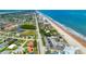 Aerial view of beach condos providing convenient access to beaches, local businesses, residential neighborhoods, and roadways at 935 Ocean Shore Blvd # 4010, Ormond Beach, FL 32176