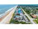 Aerial view of oceanfront condos offering beach access, community pool, parking, and proximity to commercial development at 935 Ocean Shore Blvd # 4010, Ormond Beach, FL 32176