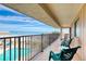 Wide balcony with pool and ocean views, featuring rocking chairs and lounge chairs at 935 Ocean Shore Blvd # 4010, Ormond Beach, FL 32176