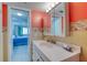 Practical bathroom features a white vanity, tiled walls, and patterned shower curtain at 935 Ocean Shore Blvd # 4010, Ormond Beach, FL 32176