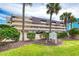 Bent Palm Club Condo features a multi-level building with parking and lush landscaping near the sign at 935 Ocean Shore Blvd # 4010, Ormond Beach, FL 32176