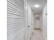 Hallway with white wood floors, white doors, and a large closet for storing personal belongings at 935 Ocean Shore Blvd # 4010, Ormond Beach, FL 32176