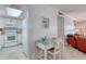 Cozy living space with white wainscotting and a connecting kitchen featuring matching appliances and wood counters at 935 Ocean Shore Blvd # 4010, Ormond Beach, FL 32176