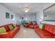 Spacious living room with ceiling fan, tile flooring, two couches, and two chairs at 935 Ocean Shore Blvd # 4010, Ormond Beach, FL 32176