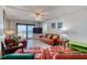 Comfortable living room featuring orange leather furniture, beach themed decor, and sliding glass doors to a balcony at 935 Ocean Shore Blvd # 4010, Ormond Beach, FL 32176