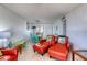 Comfortable living room with wood floors, colorful decor, and a view into the dining area at 935 Ocean Shore Blvd # 4010, Ormond Beach, FL 32176