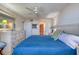 Inviting main bedroom with a large bed, ceiling fan, and adjacent bathroom and closet at 935 Ocean Shore Blvd # 4010, Ormond Beach, FL 32176