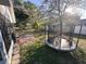 Spacious backyard featuring a trampoline and a mix of open lawn and mature trees at 1031 Tony Cir, St Cloud, FL 34772