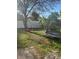 Green backyard featuring a swing and trampoline with privacy fence at 1031 Tony Cir, St Cloud, FL 34772