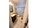 Tiled bathroom featuring a vanity with sink, toilet, and shower with stylish curtain at 1031 Tony Cir, St Cloud, FL 34772