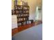 A cozy bedroom shows hardwood floors and a decorative bookshelf with natural light at 1031 Tony Cir, St Cloud, FL 34772