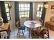 The dining area showcases a round wooden table, wood chairs, and large windows for natural light at 1031 Tony Cir, St Cloud, FL 34772