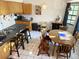 A dining table with seating is set near a kitchen bar and offers natural light from a window at 1031 Tony Cir, St Cloud, FL 34772