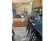 An eat-in kitchen features bar seating and flows into a living area with natural light at 1031 Tony Cir, St Cloud, FL 34772