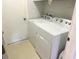 Practical laundry room with a washing machine and dryer set, with a door leading to the outside at 1031 Tony Cir, St Cloud, FL 34772