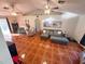 Cozy living room featuring vaulted ceiling, ceiling fans, and a large comfortable sectional sofa at 1031 Tony Cir, St Cloud, FL 34772