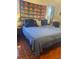 A large primary bedroom showcasing a large bed with decorative throw pillows and quilt at 1031 Tony Cir, St Cloud, FL 34772